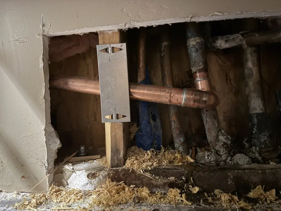 Leak detection: wall opened to a corroded copper leak, Desert Water job
